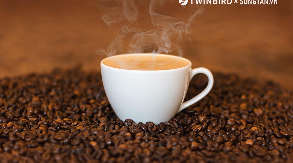 Ground coffee in wooden spoon. Coffee fried grain on wooden platter. Close-up. Coffee ground, coffee beans.